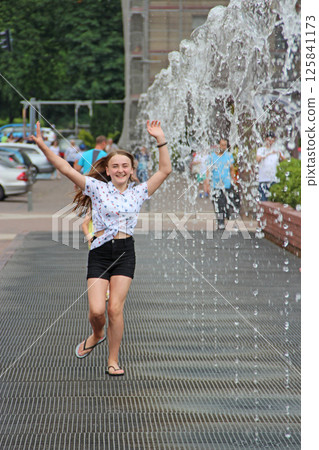little girl having fun in fountains. Hot summer weather in city little girl having fun in fountains. Hot summer weather in city 125841173