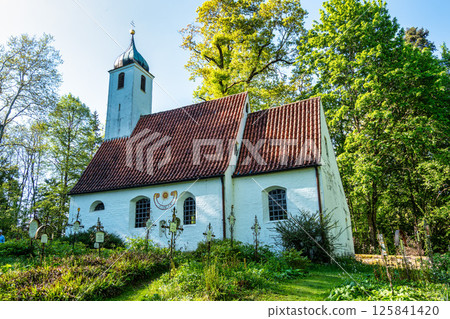 Church St.Clemens in Kranzberg near Freising, Bavaria with ancient graveyard and beautiful old wrought iron crosses 125841420