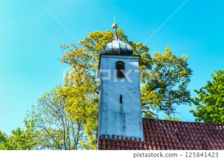 Church St.Clemens in Kranzberg near Freising, Bavaria with ancient graveyard and beautiful old wrought iron crosses Church St.Clemens in Kranzberg near Freising, Bavaria with ancient graveyard and beautiful old wrought iron crosses 125841423