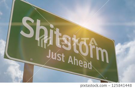 Shitstorm Just Ahead Green Road Sign Against a Blue Sky and Clouds. 125841448