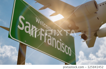 Welcome To San Francisco Green Road Sign Against a Blue Sky and Clouds with Low Flying Airplane Above. 125841452