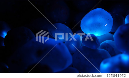Blue stones glow underwater at night 125841952