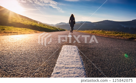 A person walking down a road / A symbolic composition evoking the future and a journey A person walking down a road / A symbolic composition evoking the future and a journey 125842075