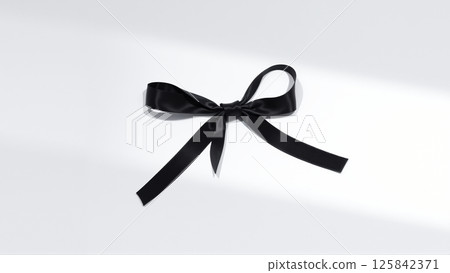 Black mourning ribbon and bow on a white background 125842371
