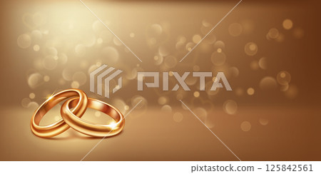 Two intertwined gold wedding rings. 125842561