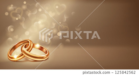 Two intertwined gold wedding rings and small hearts. Two intertwined gold wedding rings and small hearts. 125842562