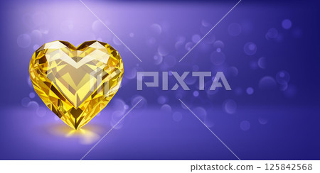 Faceted yellow heart-shaped gemstone on blue. 125842568