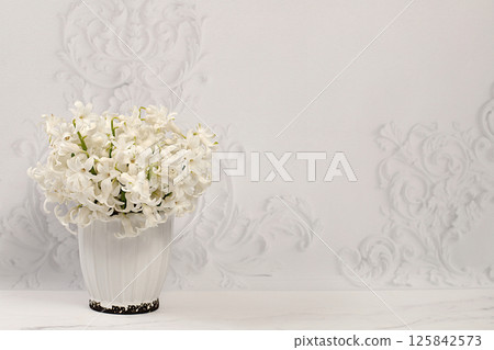 Abstract floral composition. Beautiful banner with snow-white hyacinths and blue muscari in a vase on an elegant modern background, template for design and screen. Spring card, gift for loved ones. 125842573