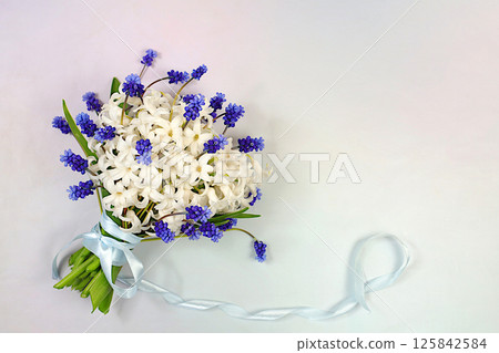 Beautiful bouquet of white hyacinth and muscari. Abstract flower arrangement for screen and design template. Spring greeting card, elegant beauty concept, gift for loved ones, 125842584