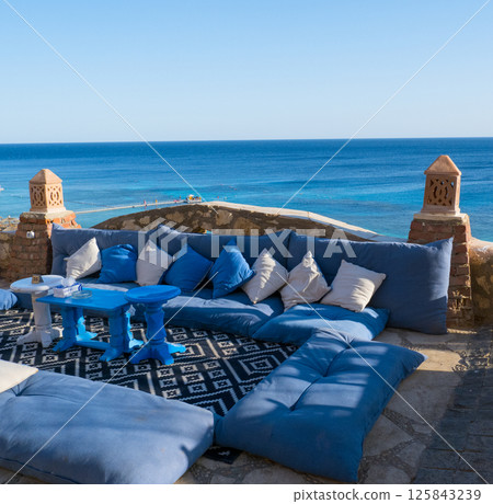 Beautiful white and blue street cafe on the seashore. Beautiful white and blue street cafe on the seashore. 125843239