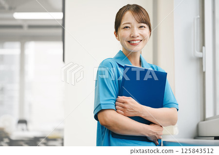 Portrait of a woman wearing a light blue polo shirt Portrait of a woman wearing a light blue polo shirt 125843512