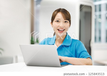 Portrait of a woman wearing a light blue polo shirt Portrait of a woman wearing a light blue polo shirt 125843513