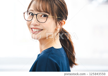 Portrait of a career woman in her 40s wearing glasses Portrait of a career woman in her 40s wearing glasses 125843550