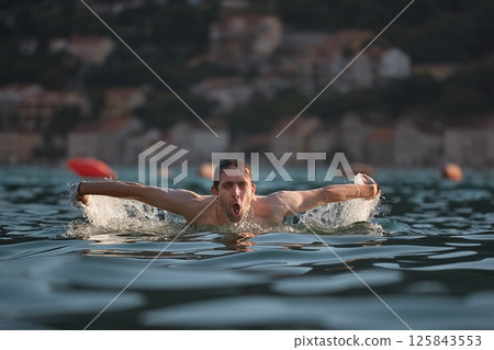 Man swimming in the sea 125843553