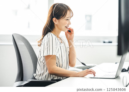 Middle woman working in a call center 125843606