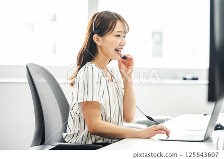 Middle woman working in a call center 125843607