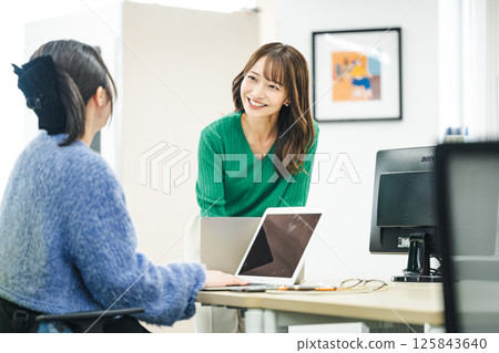 一位中年職業婦女在辦公室與同事交談 125843640