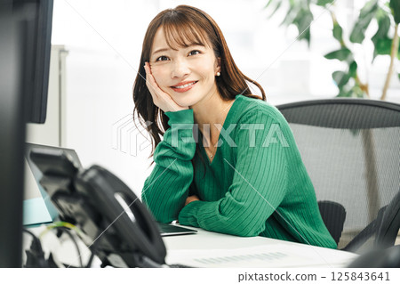 A career woman in her 40s working in an office 125843641