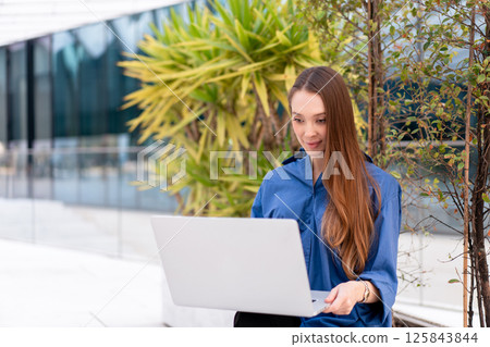 Confident female entrepreneur in blue shirt 125843844