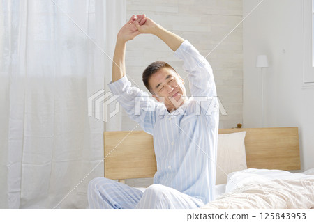 Middle-aged man stretching and waking up 125843953
