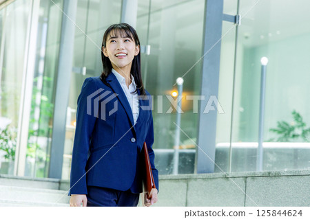 Woman walking through a stylish office 125844624