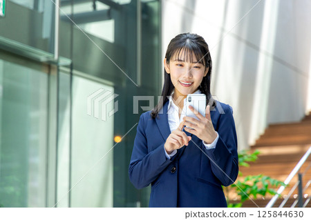 Business woman operating a smartphone 125844630