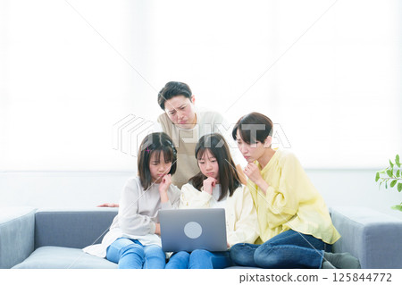 Family using a computer with a troubled look on their face Family using a computer with a troubled look on their face 125844772