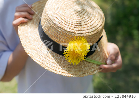 A girl with a straw hat A girl with a straw hat 125844916
