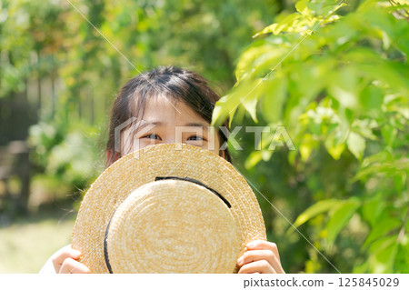 Girl with straw hat Girl with straw hat 125845029