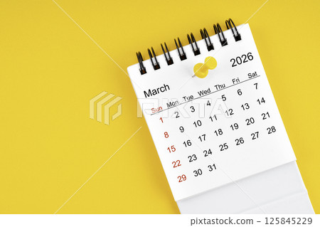 March 2026 Monthly desk calendar for 2026 year with thumbtack on yellow background. March 2026 Monthly desk calendar for 2026 year with thumbtack on yellow background. 125845229
