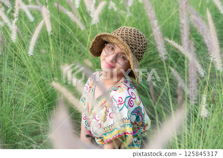 Woman (LGBTQ) posing at flower park garden field 125845317