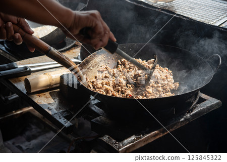 Rice topped with stir-fried pork or beef and basil 125845322
