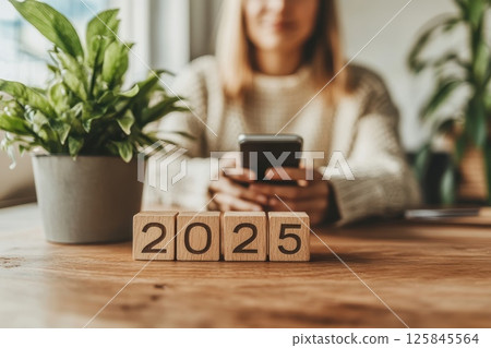 Minimalist Office Desk with Plant and Wooden Blocks displaying 2025 125845564