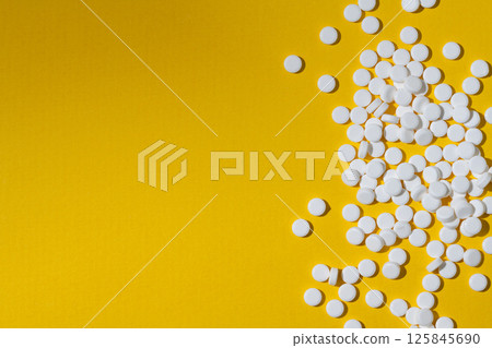 Sugar substitute, sweetener pills over yellow background. Food supplement. Diabetic, over weight, health concept. Sugar substitute, sweetener pills over yellow background. Food supplement. Diabetic, over weight, health concept. 125845690