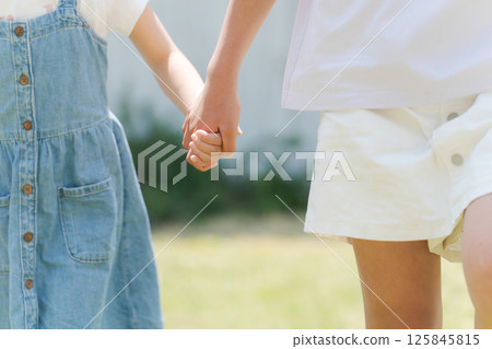 Sisters who walk hand in hand Sisters who walk hand in hand 125845815