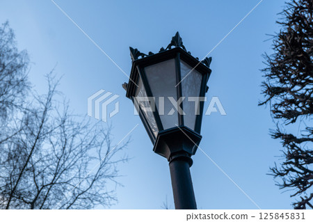 Vintage street lamp against clear blue sky in winter Vintage street lamp against clear blue sky in winter 125845831