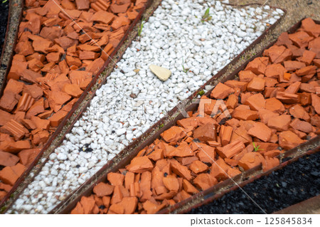 Geometric garden path with red and white stones Geometric garden path with red and white stones 125845834