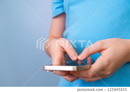 Child using smartphone for gaming or communication close-up Child using smartphone for gaming or communication close-up 125845835