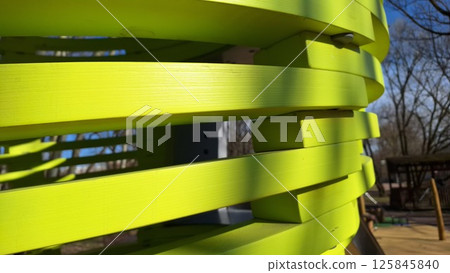 Green spiral structure in outdoor playground on sunny day 125845840