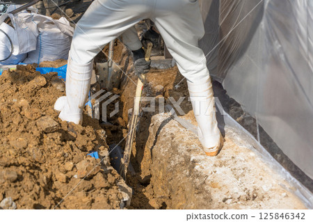 Civil engineer installing sewer pipes 125846342