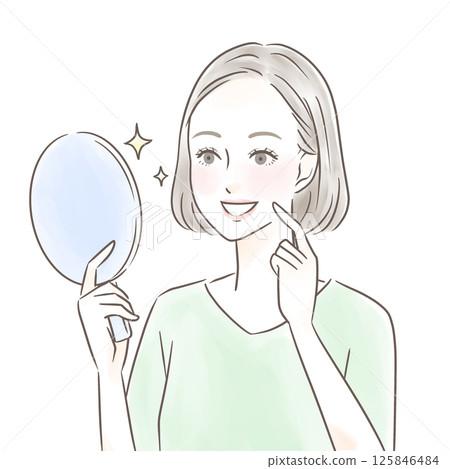 A woman is impressed by her beautiful teeth when she looks at herself in a hand mirror 125846484
