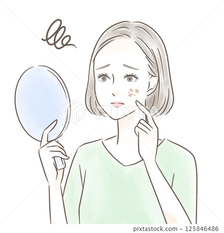 A woman worries about spots while looking at a hand mirror 125846486