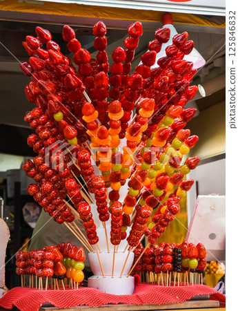 Candied fruits on sticks at a street food stall in Shanghai, on historic Yunnan Road, showcasing traditional Chinese sweets Candied fruits on sticks at a street food stall in Shanghai, on historic Yunnan Road, showcasing traditional Chinese sweets 125846832