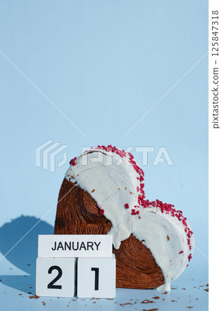 National hug day 21 January wooden calendar cubes wishes greeting holiday card Heartshaped pastry croissant treat topped with colorful frosting galore. Food experimentation viral dessert baking trend National hug day 21 January wooden calendar cubes wishes greeting holiday card Heartshaped pastry croissant treat topped with colorful frosting galore. Food experimentation viral dessert baking trend 125847318