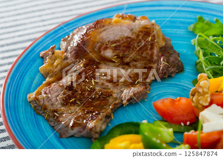Fried beef loin with summer salad 125847874