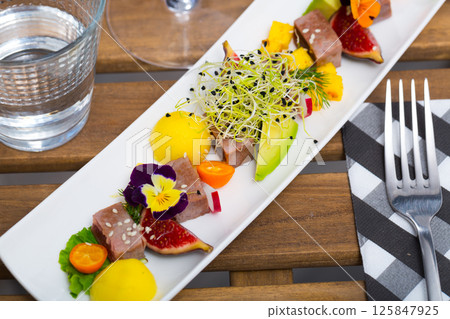 Delicious roasted tuna served with mango 125847925