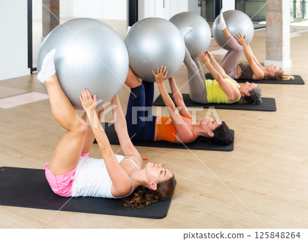 Pilates - women with exercise ball 125848264