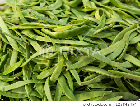Many of young bean pods at market for sale 125848454