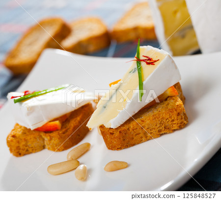 Canapes with soft blue cheese and orange 125848527