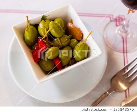 Green olives served with pepper and garlic 125848570